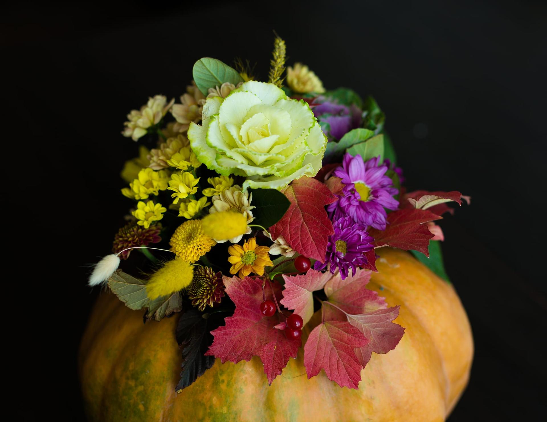 A festive Thanksgiving flower arrangement in a pumpkin