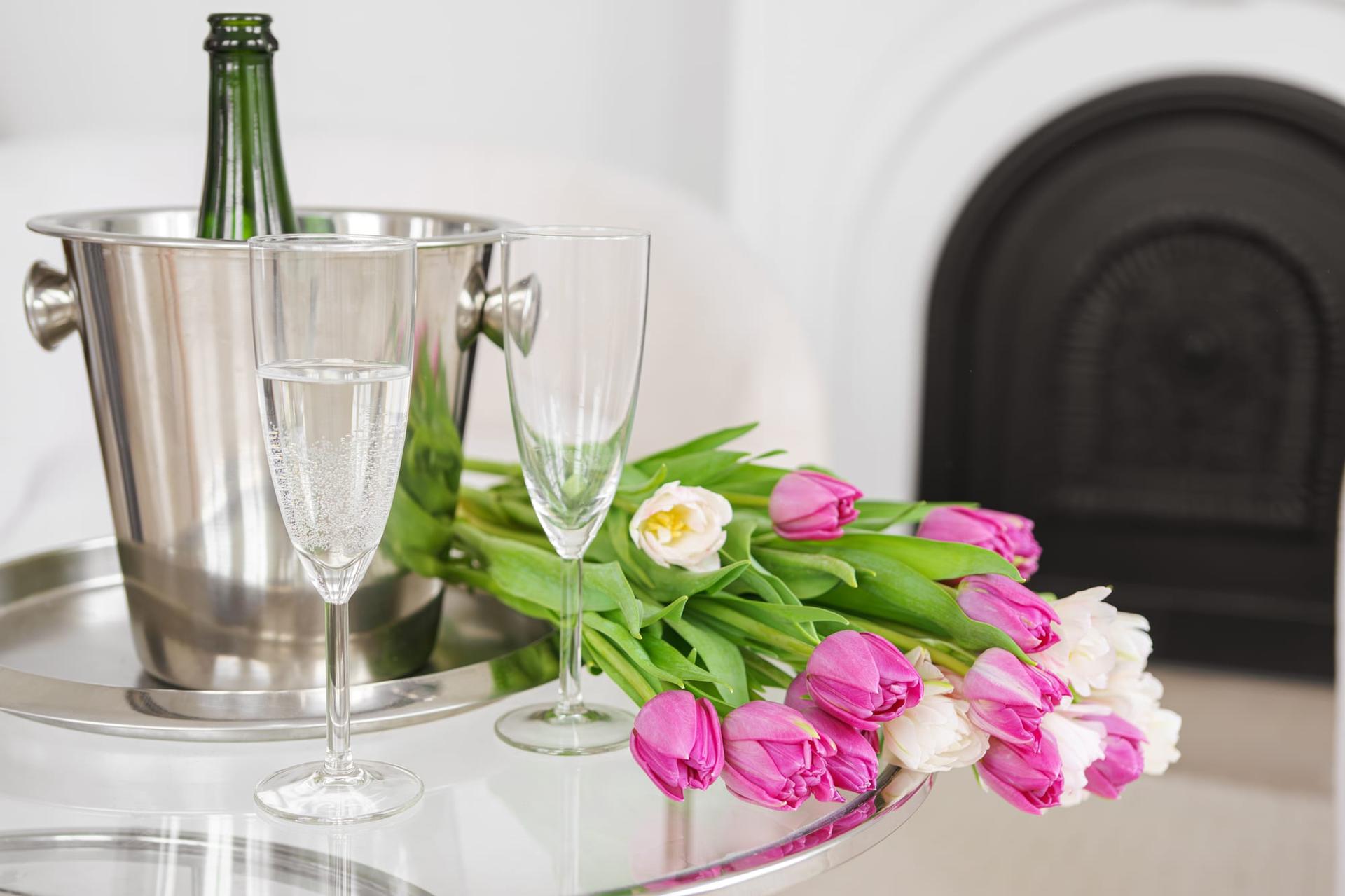 A celebratory bouquet of tulips with sparkling glasses