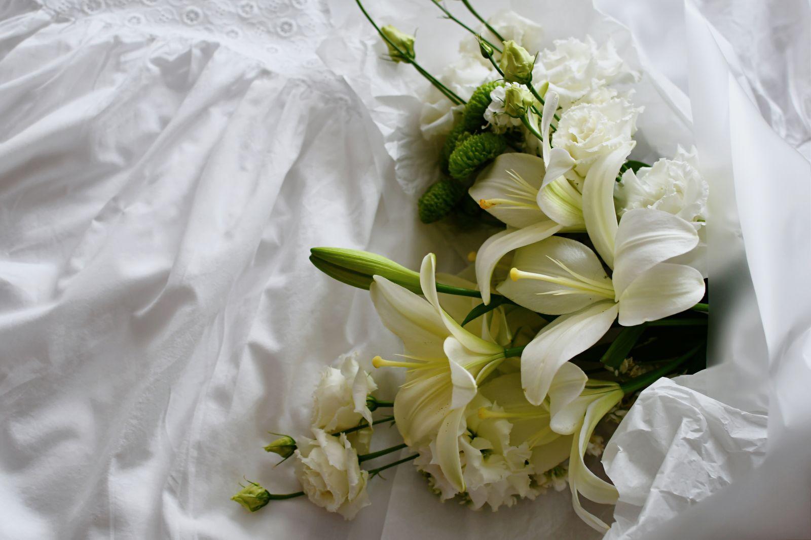 White lily and lisianthus bouquet wrapped in tissue paper