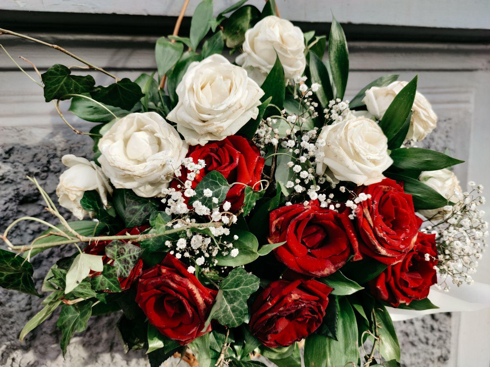 Bouquet of red and white roses with baby's breath and greenery