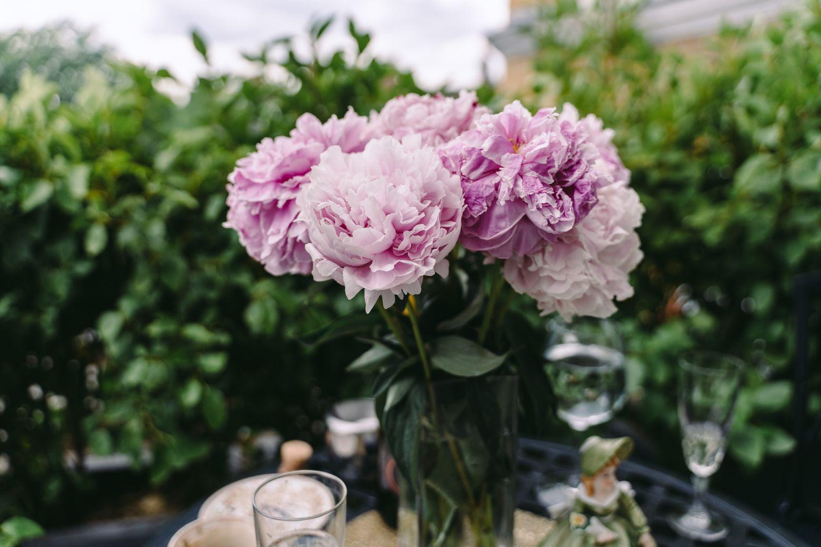 Bouquet of fresh pink peonies in a vase on a table