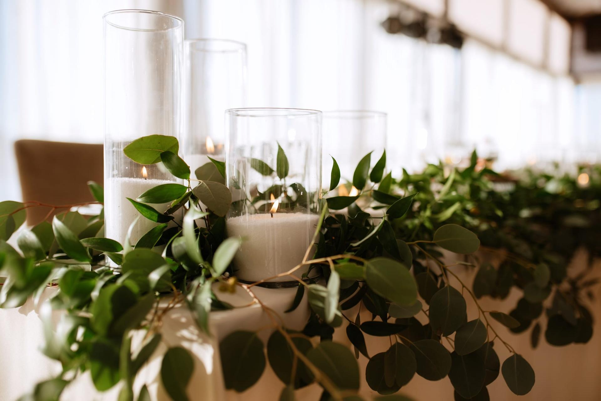 A greenery-dressed head table at a wedding banquet